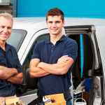 Father and son in front of family business work truck