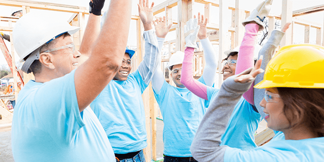 Construction crew volunteering to build a house